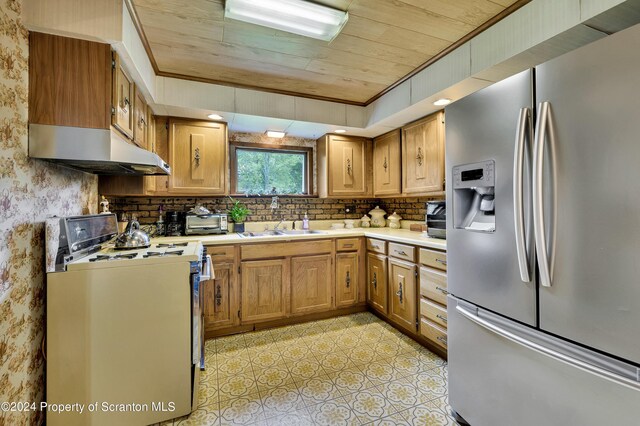 kitchen featuring stainless steel fridge, electric stove, sink, and wood ceiling