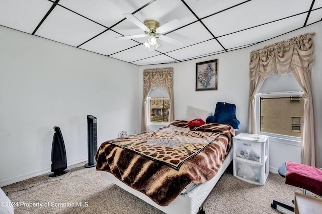 bedroom featuring multiple windows, carpet, and ceiling fan