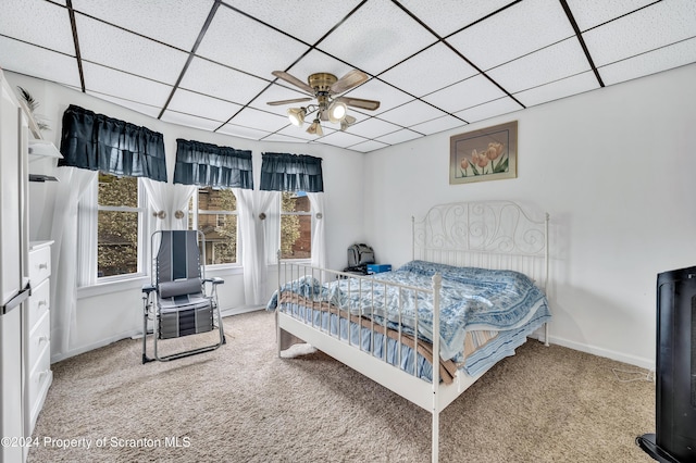 bedroom with carpet flooring, a paneled ceiling, and ceiling fan