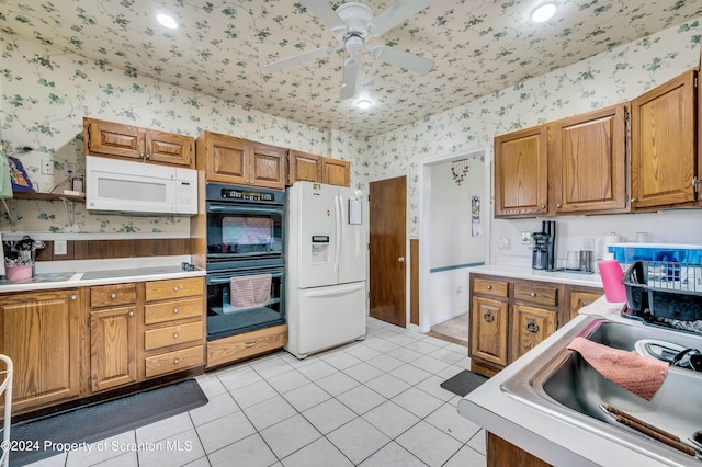 kitchen with ceiling fan, sink, light tile patterned flooring, and white appliances