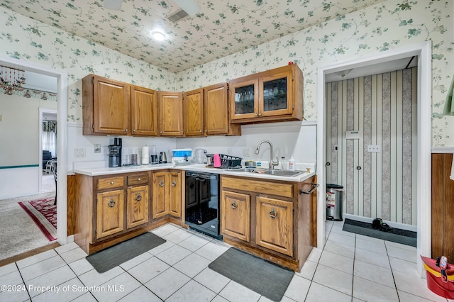 kitchen with dishwasher, light tile patterned floors, and sink