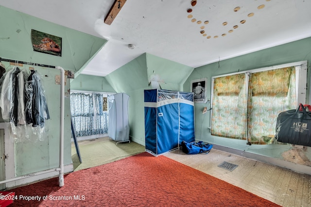 bedroom featuring carpet and lofted ceiling