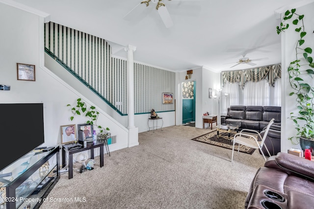 carpeted living room with decorative columns, ceiling fan, and ornamental molding