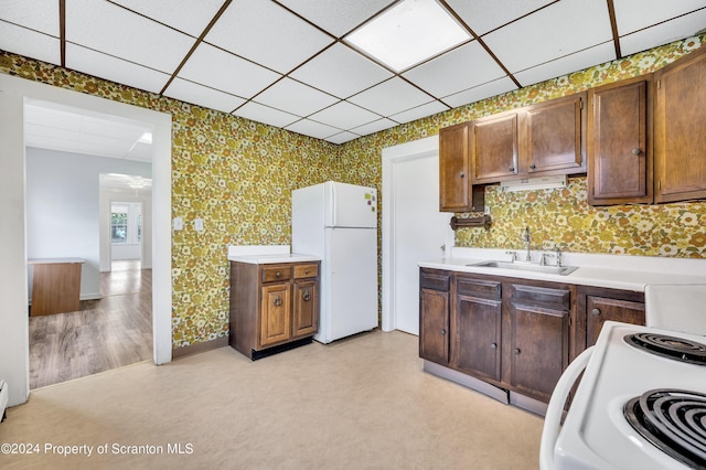 kitchen featuring white appliances and sink