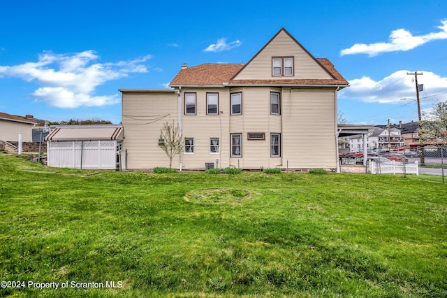 rear view of house with a lawn