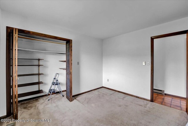 906 Violet Ter, Clarks Summit, PA 18411 - unfurnished bedroom featuring carpet flooring, a closet, baseboards, and a baseboard radiator