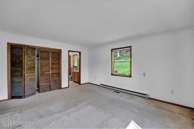 906 Violet Ter, Clarks Summit, PA 18411 - unfurnished bedroom featuring baseboards, a baseboard heating unit, carpet flooring, and connected bathroom
