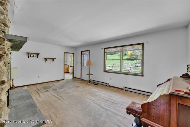 906 Violet Ter, Clarks Summit, PA 18411 - living area featuring light colored carpet, baseboards, and baseboard heating