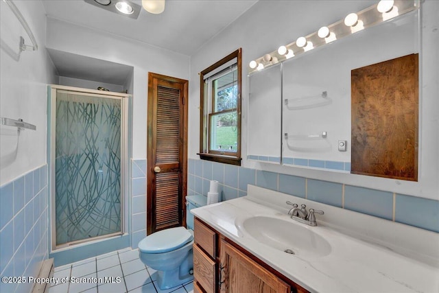 906 Violet Ter, Clarks Summit, PA 18411 - bathroom with vanity, tile walls, tile patterned flooring, and a stall shower