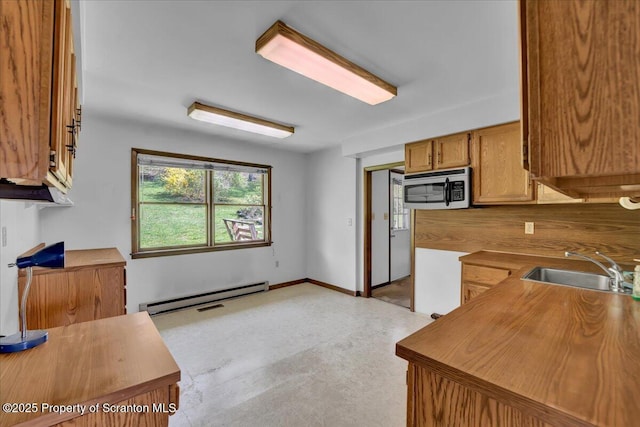 906 Violet Ter, Clarks Summit, PA 18411 - kitchen featuring baseboard heating, stainless steel microwave, brown cabinetry, and a sink