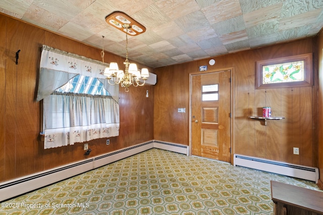 817 Miles Ave, Dickson City, PA 18447 - interior space with wooden walls, a chandelier, and a baseboard radiator