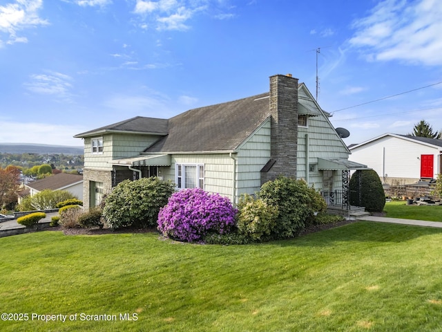 817 Miles Ave, Dickson City, PA 18447 - view of property exterior with roof with shingles, a chimney, and a yard