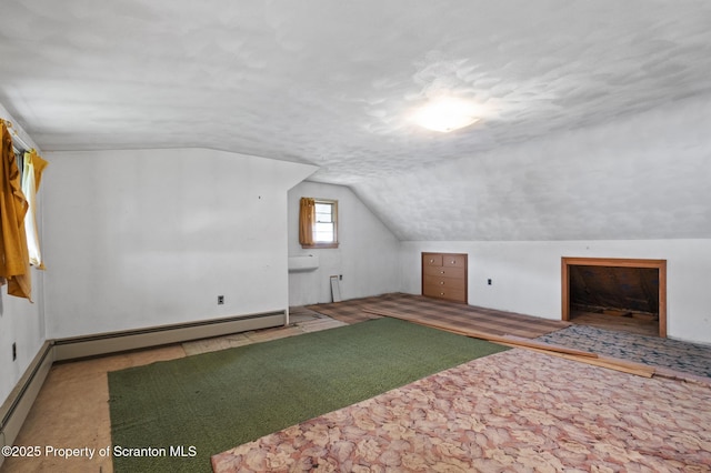 817 Miles Ave, Dickson City, PA 18447 - bonus room featuring carpet, baseboard heating, vaulted ceiling, and a textured ceiling
