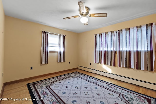 817 Miles Ave, Dickson City, PA 18447 - empty room with a baseboard radiator, light wood-type flooring, a ceiling fan, and baseboards