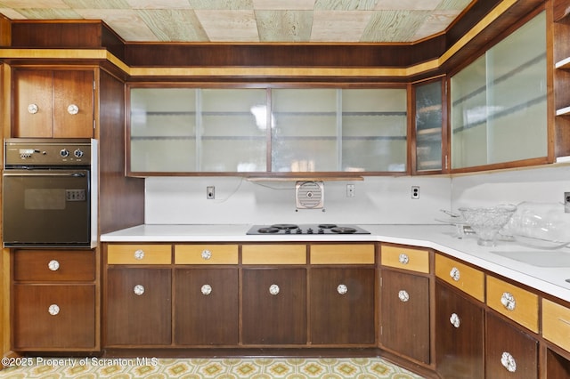 817 Miles Ave, Dickson City, PA 18447 - kitchen featuring glass insert cabinets, black appliances, and light countertops