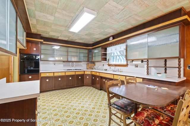 817 Miles Ave, Dickson City, PA 18447 - kitchen featuring open shelves, black oven, a sink, light countertops, and cooktop