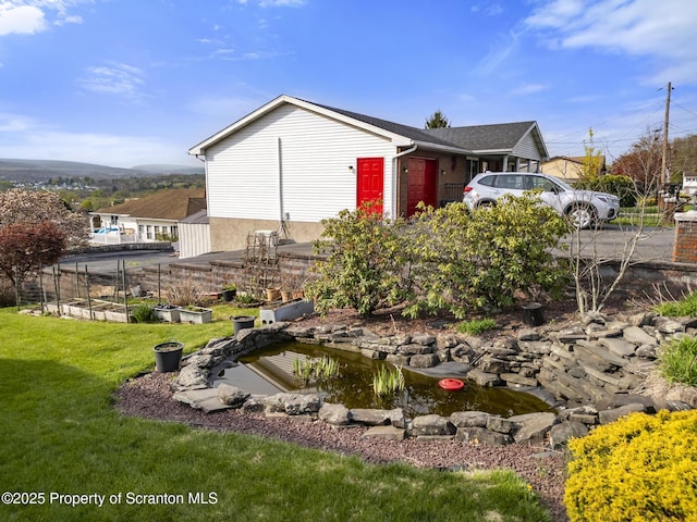 817 Miles Ave, Dickson City, PA 18447 - view of home's exterior with a yard and a garden pond