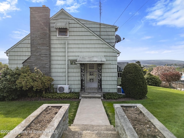 817 Miles Ave, Dickson City, PA 18447 - view of front facade featuring a chimney, a front lawn, and ac unit
