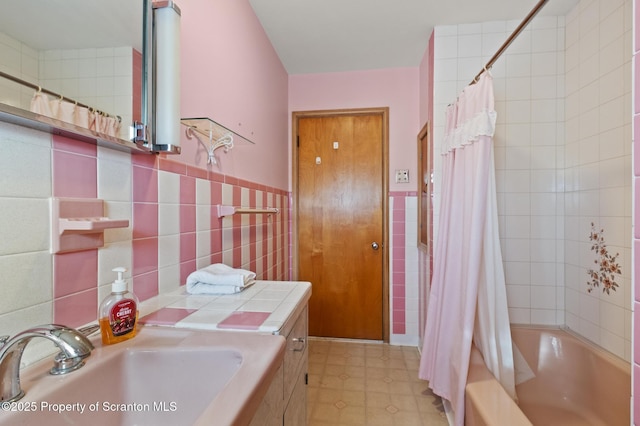 817 Miles Ave, Dickson City, PA 18447 - full bathroom with shower / tub combo, a wainscoted wall, tile walls, and a sink