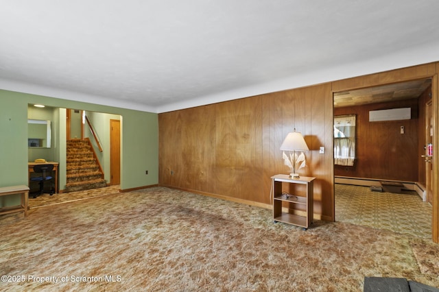 817 Miles Ave, Dickson City, PA 18447 - unfurnished living room with a wall mounted air conditioner, carpet, wood walls, and stairway