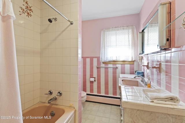 817 Miles Ave, Dickson City, PA 18447 - full bathroom featuring shower / bath combo, a baseboard radiator, toilet, tile walls, and wainscoting