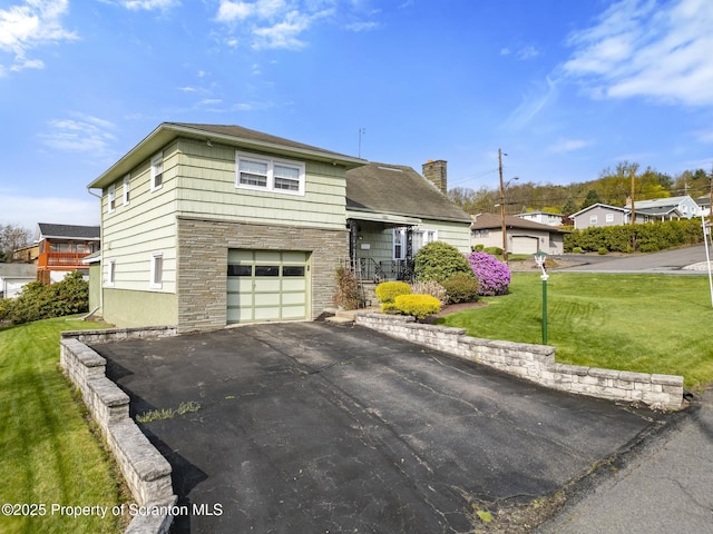 817 Miles Ave, Dickson City, PA 18447 - split level home with a front lawn, driveway, stone siding, a chimney, and an attached garage