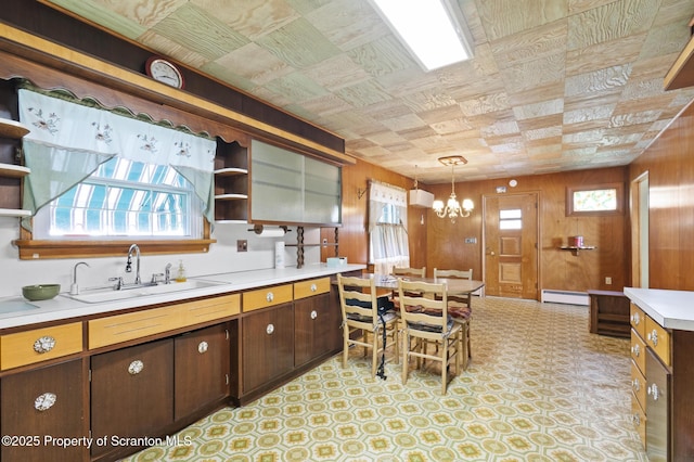 817 Miles Ave, Dickson City, PA 18447 - kitchen featuring open shelves, a sink, light countertops, baseboard heating, and a notable chandelier