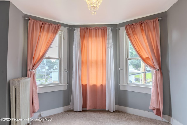 51 Plank St, Pittston, PA 18640 - empty room with light colored carpet, radiator, and a chandelier