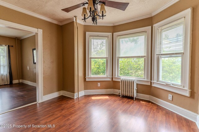 51 Plank St, Pittston, PA 18640 - empty room featuring radiator heating unit, wood finished floors, ceiling fan, a textured ceiling, and crown molding