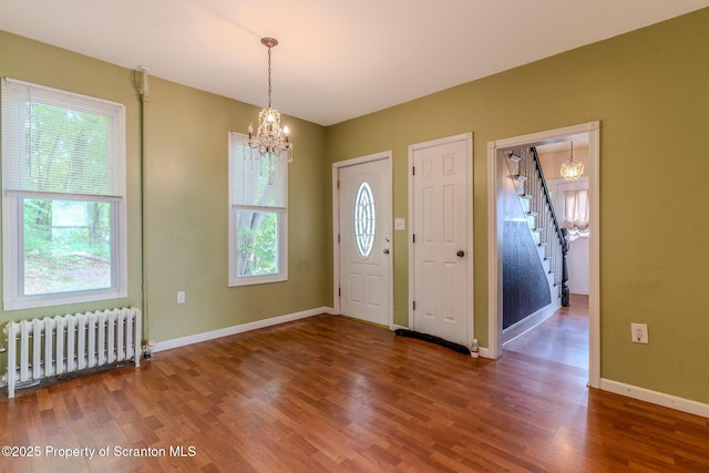 51 Plank St, Pittston, PA 18640 - foyer with radiator, a chandelier, stairway, and wood finished floors