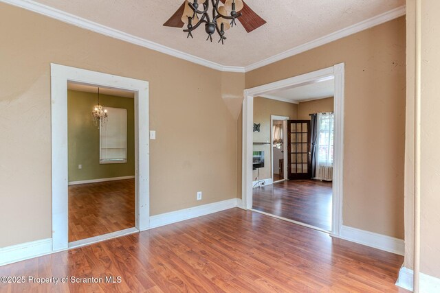 51 Plank St, Pittston, PA 18640 - spare room with a chandelier, wood finished floors, crown molding, radiator, and a textured ceiling