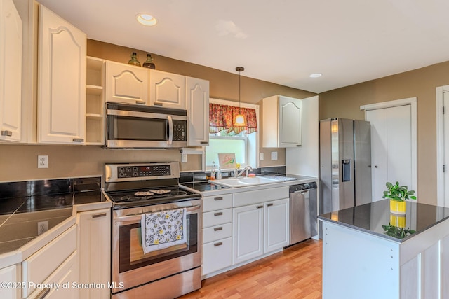 51 Plank St, Pittston, PA 18640 - kitchen featuring stainless steel appliances, hanging light fixtures, light wood finished floors, white cabinets, and open shelves