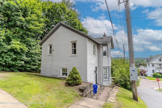51 Plank St, Pittston, PA 18640 - view of property exterior with a lawn and a chimney