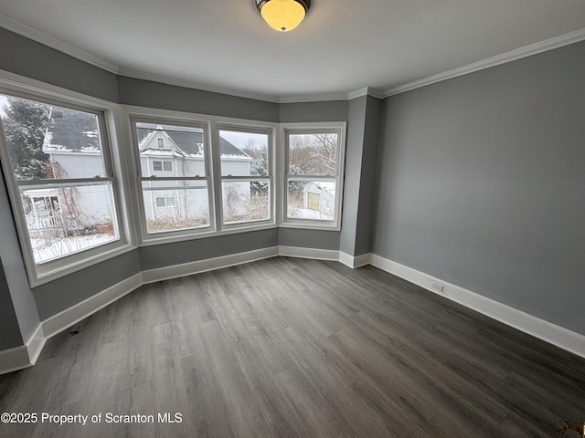 spare room featuring crown molding and hardwood / wood-style flooring