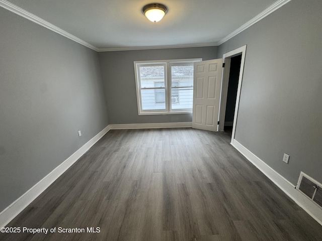 unfurnished room featuring dark hardwood / wood-style flooring and crown molding