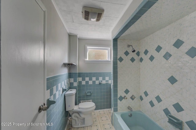 446 10th Ave, Scranton, PA 18504 - full bathroom with tile walls, shower / washtub combination, and a wainscoted wall