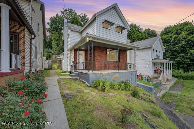 446 10th Ave, Scranton, PA 18504 - view of front of home with a porch and brick siding