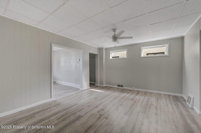 446 10th Ave, Scranton, PA 18504 - spare room with wood finished floors, ceiling fan, a drop ceiling, and wooden walls