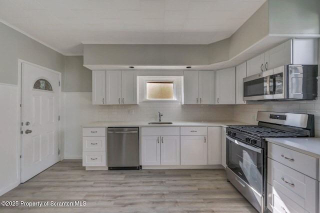 446 10th Ave, Scranton, PA 18504 - kitchen with stainless steel appliances, light countertops, and white cabinetry