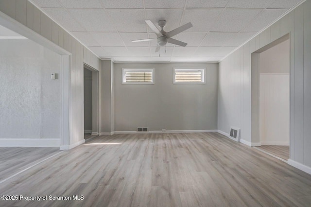 446 10th Ave, Scranton, PA 18504 - unfurnished room featuring a ceiling fan, wood finished floors, wood walls, and a drop ceiling