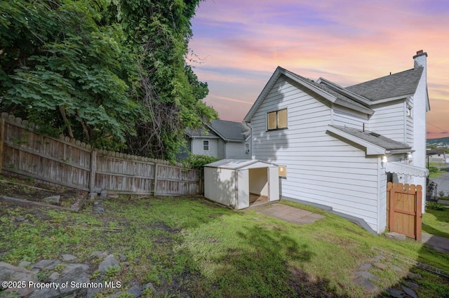 446 10th Ave, Scranton, PA 18504 - rear view of house with a storage shed, roof with shingles, and a chimney