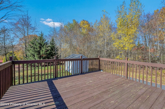 wooden deck featuring a shed