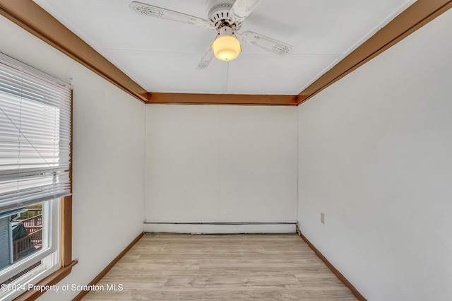 spare room with a baseboard radiator, ceiling fan, and light hardwood / wood-style floors