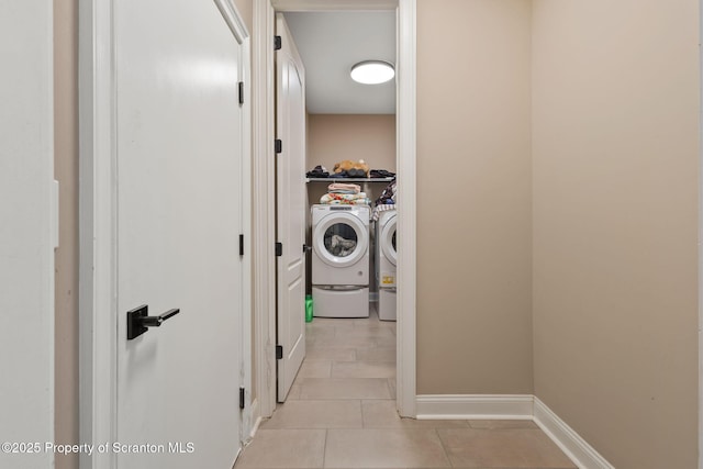 laundry area with light tile patterned floors and washing machine and dryer