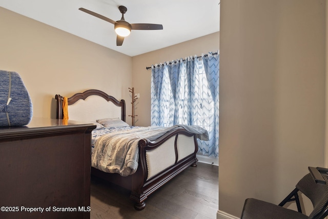 bedroom with ceiling fan and dark hardwood / wood-style flooring