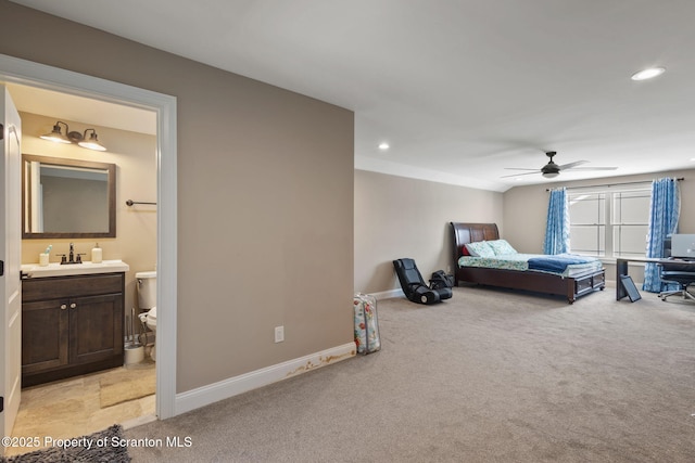 carpeted bedroom featuring ensuite bath and ceiling fan