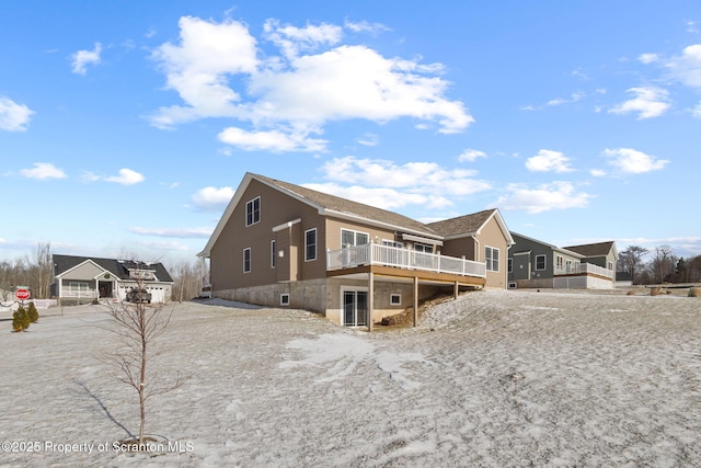 rear view of property with a wooden deck