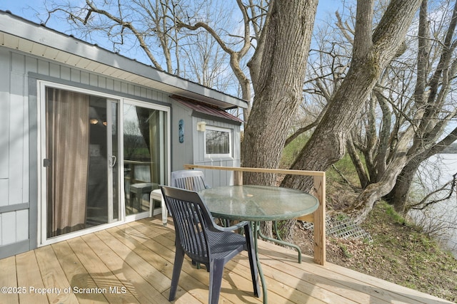 wooden terrace with outdoor dining area