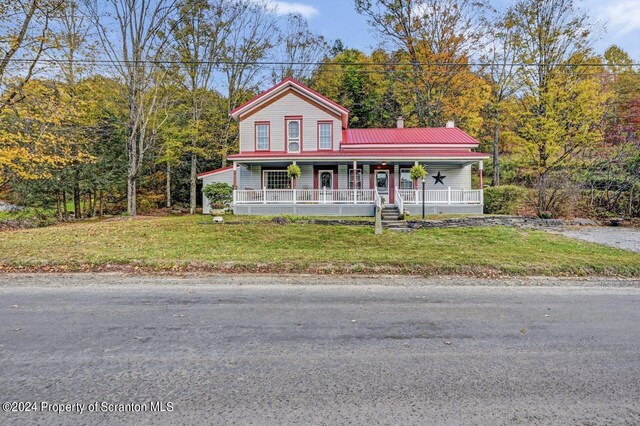 view of front of house with covered porch and a front yard