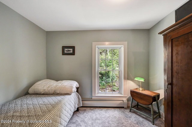 carpeted bedroom with a baseboard radiator